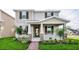 Charming two-story home featuring a welcoming front porch and professionally landscaped front yard at 9106 Cut Shot Dr, Winter Garden, FL 34787
