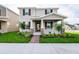 Beautiful two-story home with a covered front porch and lush landscaping in a serene neighborhood at 9106 Cut Shot Dr, Winter Garden, FL 34787