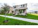 Beautiful two-story home with a covered front porch and lush landscaping in a serene neighborhood at 9106 Cut Shot Dr, Winter Garden, FL 34787