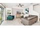 Bright living room with a fan, modern furniture, stylish decor, and sliding glass doors to the outside at 9106 Cut Shot Dr, Winter Garden, FL 34787