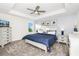 Comfortable main bedroom with tray ceiling, carpet flooring, bright natural light, and soothing decor at 9106 Cut Shot Dr, Winter Garden, FL 34787