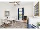 Well-lit home office with a clean desk space, comfortable seating, and a neutral color palette at 9106 Cut Shot Dr, Winter Garden, FL 34787