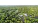 Expansive wooded lot showcases a home with a metal roof and a matching metal barn at 920 Grand Ave, Orange City, FL 32763