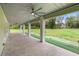 Spacious covered back porch with ceiling fans and a view of the expansive green yard at 920 Grand Ave, Orange City, FL 32763