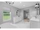 Bright bathroom with double vanities, soaking tub, and large window at 920 Grand Ave, Orange City, FL 32763