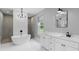 Modern bathroom with a soaking tub, white cabinets, marble countertops, and stylish fixtures at 920 Grand Ave, Orange City, FL 32763