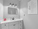 Bathroom vanity with marble countertop, stylish mirror, and modern lighting at 920 Grand Ave, Orange City, FL 32763