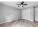 Bedroom featuring wood-look floors, ceiling fan, and closet at 920 Grand Ave, Orange City, FL 32763