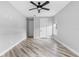 Bedroom featuring wood-look floors, ceiling fan, and natural light at 920 Grand Ave, Orange City, FL 32763