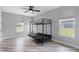 Bedroom with a bunk bed, two large windows, and wood-look flooring at 920 Grand Ave, Orange City, FL 32763
