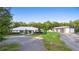 Attractive property with metal barn, landscaping, and a charming single-story home with a metal roof at 920 Grand Ave, Orange City, FL 32763