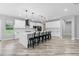 Bright, modern kitchen with white cabinetry, a large center island with seating, and a stainless steel appliance package at 920 Grand Ave, Orange City, FL 32763