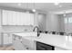 An oversized kitchen island with a farmhouse sink, pendant lighting, and seating for six, plus ample counter space at 920 Grand Ave, Orange City, FL 32763