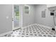 Laundry room with decorative tile floor, a utility sink, and exterior access at 920 Grand Ave, Orange City, FL 32763