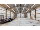 Spacious outbuilding interior with high ceilings, ample lighting, and roll-up doors at 920 Grand Ave, Orange City, FL 32763