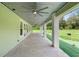 Covered patio with ceiling fan and views of the large backyard at 920 Grand Ave, Orange City, FL 32763