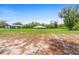 Expansive green property view showcasing the home and detached garage at 920 Grand Ave, Orange City, FL 32763
