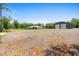 Wide view showcasing home and detached garage, surrounded by open land at 920 Grand Ave, Orange City, FL 32763