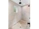 Walk-in shower featuring modern fixtures, a rainfall shower head, and concrete-look walls at 920 Grand Ave, Orange City, FL 32763