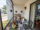 Cozy balcony with plants, wind chimes, an outdoor chair, and sliding glass door at 952 Courtyard Ln # 41, Orlando, FL 32825