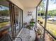 Relaxing balcony with potted plants, outdoor seating, and a view of the parking area at 952 Courtyard Ln # 41, Orlando, FL 32825