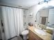 The bathroom features a shower with white curtain, toilet, and sink with granite countertop at 952 Courtyard Ln # 41, Orlando, FL 32825