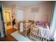 Inviting bedroom showing two wooden cribs, light pink walls, and an open doorway to the bathroom at 952 Courtyard Ln # 41, Orlando, FL 32825