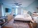 Bright bedroom with a ceiling fan, large mirror, and hardwood floors at 952 Courtyard Ln # 41, Orlando, FL 32825