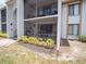 Condo exterior showing a screened balcony and well-maintained landscaping at 952 Courtyard Ln # 41, Orlando, FL 32825