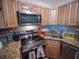 This kitchen features stainless steel appliances, granite countertops, and light wood cabinetry at 952 Courtyard Ln # 41, Orlando, FL 32825