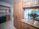 Eat-in kitchen with modern cabinetry and granite countertops leading to the living room area at 952 Courtyard Ln # 41, Orlando, FL 32825