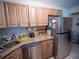 Well lit kitchen boasts stainless steel appliances, stone countertops and wooden cabinetry at 952 Courtyard Ln # 41, Orlando, FL 32825