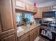 Well-lit kitchen with granite countertops, modern appliances, and a view into the dining area at 952 Courtyard Ln # 41, Orlando, FL 32825