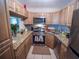 Updated kitchen features granite countertops, stainless steel appliances, and wooden cabinets at 952 Courtyard Ln # 41, Orlando, FL 32825