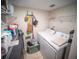 Functional laundry room featuring a washer and dryer, storage shelves, and tiled floor at 952 Courtyard Ln # 41, Orlando, FL 32825