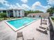 Resort-style pool with lounge chairs, umbrellas, and a hot tub at this community complex at 952 Courtyard Ln # 41, Orlando, FL 32825