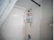 Shower stall features white tile walls, showerhead, and shelves for toiletries at 952 Courtyard Ln # 41, Orlando, FL 32825