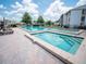 A swimming pool and a spa with lounge chairs offer an inviting place to relax at 952 Courtyard Ln # 41, Orlando, FL 32825