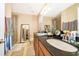 Bathroom featuring granite countertops, a large mirror, and a glass-enclosed shower at 9539 Silver Buttonwood St, Orlando, FL 32832