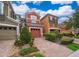 Beautiful townhomes with lovely brick driveways and vibrant green lawns, creating an inviting curb appeal at 9539 Silver Buttonwood St, Orlando, FL 32832