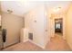 Upstairs hallway showcasing neutral walls with white trim and carpeted floors at 9539 Silver Buttonwood St, Orlando, FL 32832