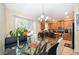 Kitchen view, stainless steel appliances, granite counters, and adjacent dining area with natural light at 9539 Silver Buttonwood St, Orlando, FL 32832