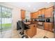 Bright eat-in kitchen features stainless steel appliances, granite counters, and a sliding glass door to the backyard at 9539 Silver Buttonwood St, Orlando, FL 32832
