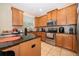 Well-lit kitchen features stainless steel appliances, granite countertops, and light wood cabinets at 9539 Silver Buttonwood St, Orlando, FL 32832
