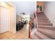 Inviting living room showcasing neutral color palette, tiled floors, and stairs leading up to the next level at 9539 Silver Buttonwood St, Orlando, FL 32832