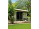Backyard featuring sliding door, small patio, and lush landscaping at 10301 Us Highway 27 # 34, Clermont, FL 34711