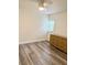 Bedroom with wood flooring and a large window providing natural light at 10301 Us Highway 27 # 34, Clermont, FL 34711