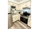 Modern kitchen featuring stainless steel appliances, granite countertops, and stylish wood-look flooring at 10301 Us Highway 27 # 34, Clermont, FL 34711