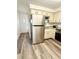 Spacious kitchen featuring stainless steel appliances, granite countertops, and wood-look flooring at 10301 Us Highway 27 # 34, Clermont, FL 34711