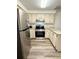 Bright kitchen equipped with stainless steel appliances, granite countertops, and wood-look flooring at 10301 Us Highway 27 # 34, Clermont, FL 34711